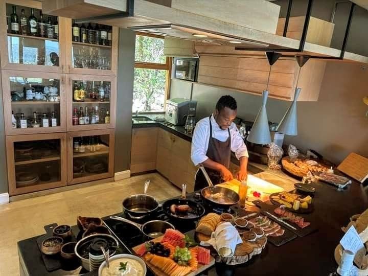 A chef working a live breakfast station at a lodge kitchen